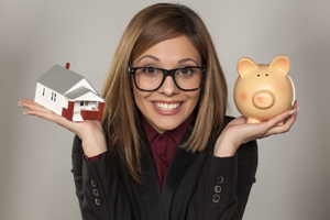 Young Lady holding a piggy bank and toy house